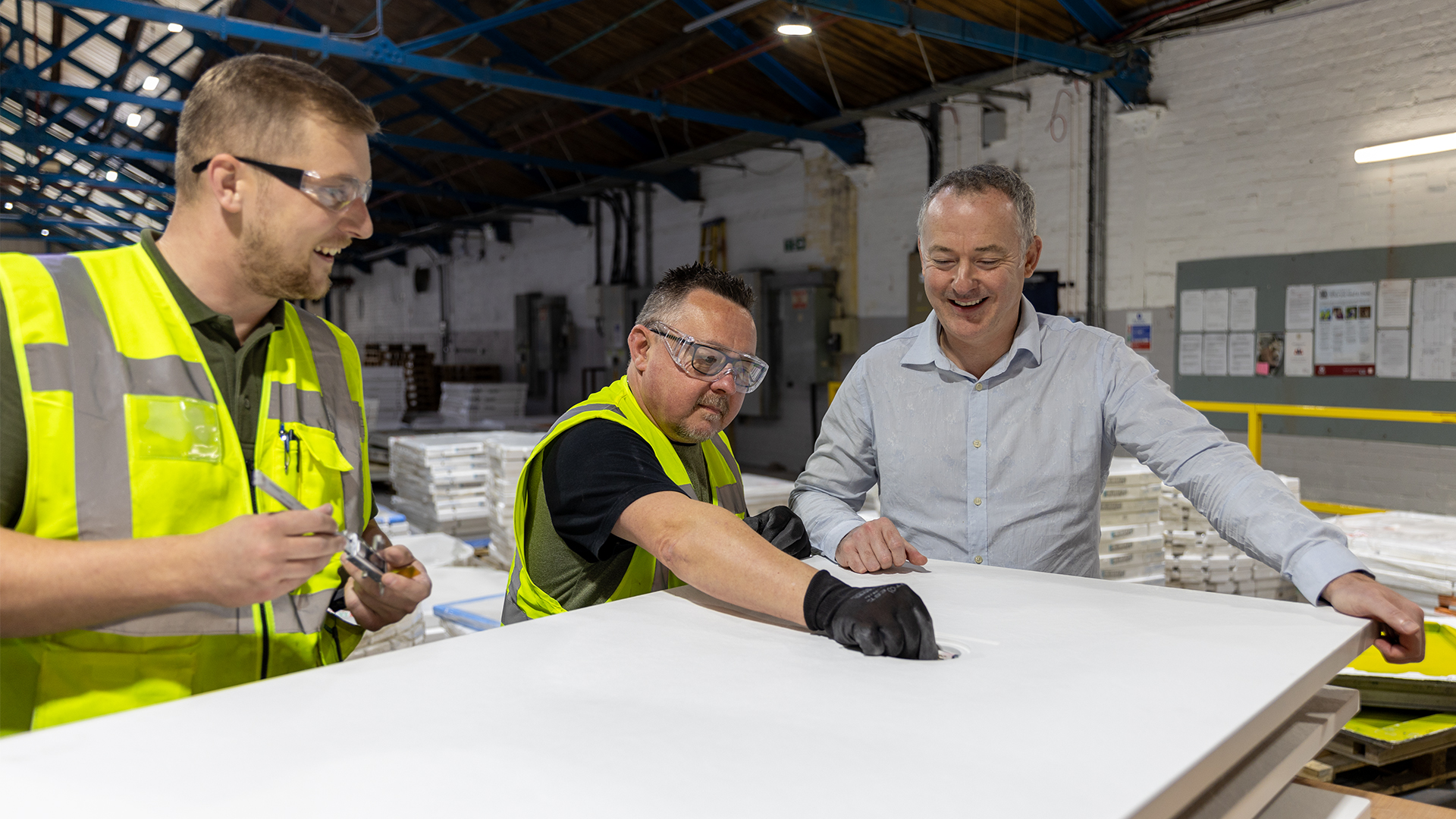 Trojan MD David Mosley with members of the manufacturing team assessing a shower tray