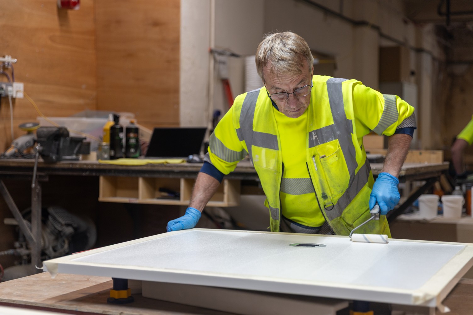 A Trojan operative applying an anti-slip coating to a gel coat tray at the company's Huddersfield factory
